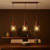 Brilliant lampada a sospensione lineare Petje per isole cucina, 3 paralumi ambrati